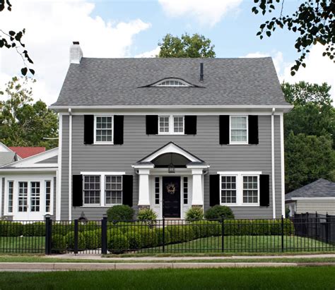 grey house brown metal roof|grey houses with black shutters.